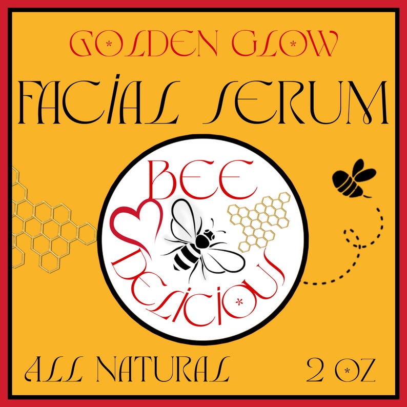 May include: A square label for Golden Glow Facial Serum. The label is yellow with a red border and features the text "Golden Glow Facial Serum" in red and black. A circular graphic in the center says "Bee Delicious" with a bee illustration. The label also says "All Natural" and "2 oz".
