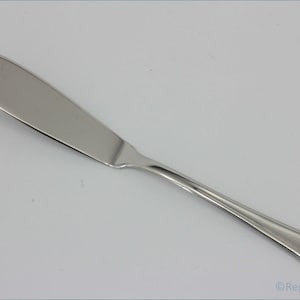May include: A silver butter knife with a slightly rounded tip and a straight handle.