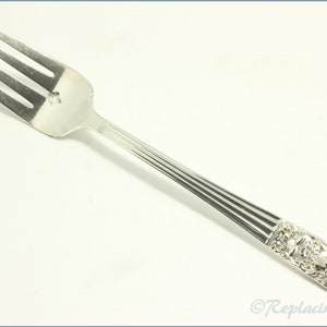 May include: Silver fork with a decorative handle featuring a floral design. The fork has a fluted handle and a polished finish.