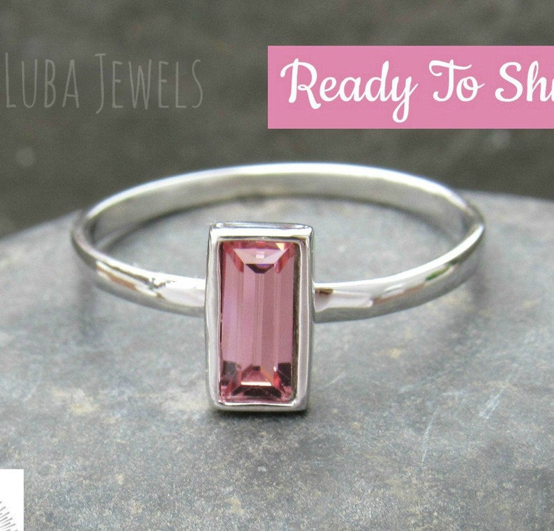 May include: A delicate silver ring with a pink rectangular gemstone. The ring is ready to ship.