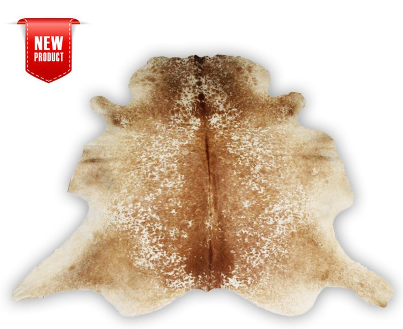 May include: A brown and white cowhide rug with a natural, spotted pattern. The rug is approximately 5 feet long and 4 feet wide.
