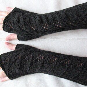 May include: A pair of black fingerless gloves with a lacy knit pattern.