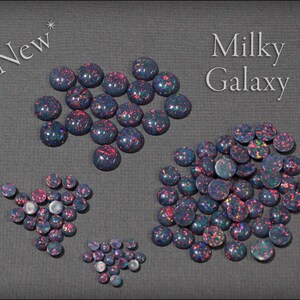 May include: Assortment of Milky Galaxy opal cabochons in various sizes. The cabochons are a mix of dark blue, black, and purple with iridescent flashes of pink and green.  *New*