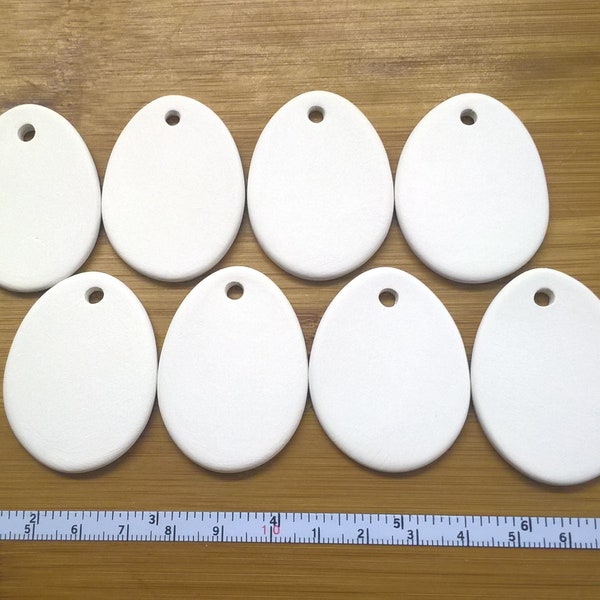 8 oval 4.5cm x 3cm bisque blanks. For painting/decoupage/etc 'cold finish' or pottery kiln firing. Super white earthenware ceramic.