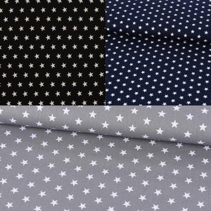Könnte beinhalten: Ein Stoffmuster mit drei Farbvarianten: Schwarz, Marineblau und Grau. Jeder Stoff ist mit weißen Sternen gemustert. Der schwarze Stoff hat weiße Sterne, der marineblaue Stoff hat weiße Sterne und der graue Stoff hat weiße Sterne.