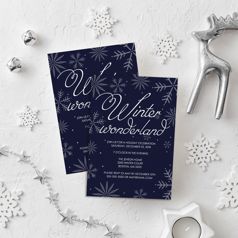 以下が含まれることがあります： 紺色の招待状に銀色の雪の結晶と「Heon Winter Wonderland」の文字が書かれており、2018年12月22日午後7時のホリデーセレブレーションの詳細が記載されています。