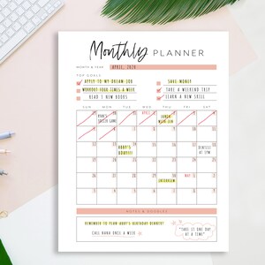 May include: A printable monthly planner with a pink and black color scheme. The planner includes a calendar for April 2024, a section for top goals, and a notes and doodles section. The top goals include "Apply to my dream job", "Workout four times a week", "Read 3 new books", "Save money", "Take a weekend trip", and "Learn a new skill".