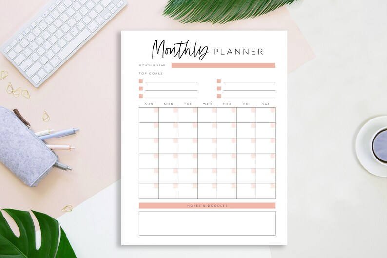 May include: A printable monthly planner with a simple design. It includes sections for month and year, top goals, a calendar grid, and notes and a to-do list.