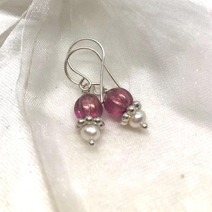 May include: A pair of silver earrings with pink glass beads and white pearl accents.