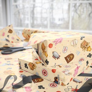 May include: A light yellow wrapping paper featuring a repeating pattern of holiday-themed illustrations including a pink bunny suit, a wooden crate labeled fragile, a vintage radio, a zeppelin, a target, and speech bubbles with the text OH FUDGE.