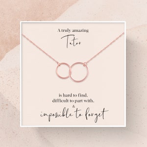 May include: A white card with a rose gold necklace featuring two interlocking circles. The card reads "A truly amazing Tutor is hard to find, difficult to part with, & impossible to forget."