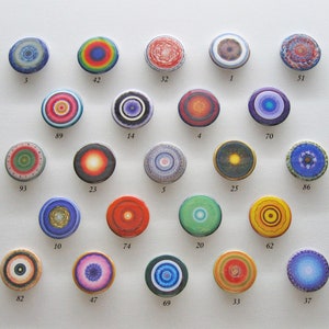 May include: A collection of 20 colorful round buttons with different mandala designs. Each button has a number printed on it.