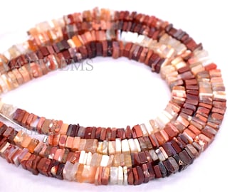 May include: A strand of red, brown, and white gemstone beads. The beads are rectangular and have a polished finish. The beads are strung on a silver wire.