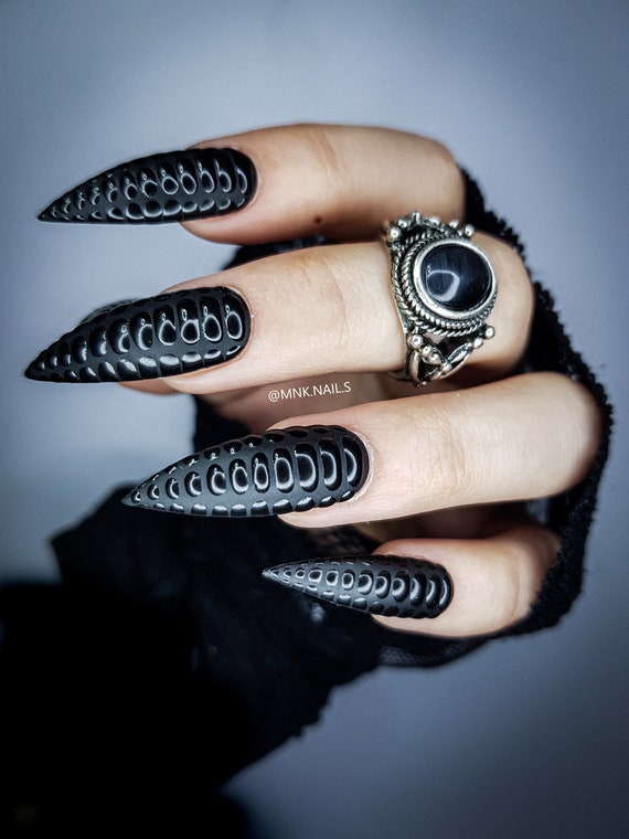 Black gothic manicure with mystic nail art. Amethyst in the hand on the  silver sparkle background. Stock Photo by ©irina_zorg 271123180