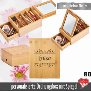 Könnte beinhalten: Eine personalisierte Bambus-Aufbewahrungsbox mit Spiegel und Schublade. Die Box ist mit dem Namen "Luisa" und einem floralen Design graviert. Die Box ist ideal zum Verstauen von Schmuck, Make-up oder anderen kleinen Gegenständen.