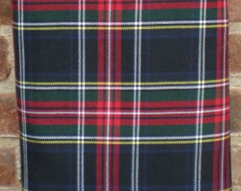 May include: A black, red, green, and white plaid fabric with a label that reads "Stoffe Lorenz Est. 1908".