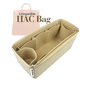 May include: Beige handbag organizer with multiple compartments and a gold zipper. The text "Compatible HAC Bag" is displayed above a pink handbag. The organizer is designed to fit inside a handbag.