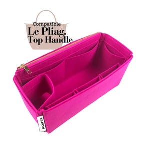 May include: A bright pink handbag organizer with multiple compartments and a gold zipper. The organizer is labeled "SILKON" and is designed to fit the Le Pliag. Top Handle bag. The image shows the organizer's interior layout.