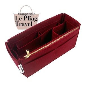 May include: A burgundy felt bag organizer with multiple compartments and a gold zipper. The organizer is designed to fit inside a Le Pliag Travel bag. The brand name "SILKON" is visible on a white label.