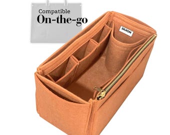 May include: A peach-colored bag organizer with multiple compartments and a gold zipper. The organizer is designed to fit inside a larger bag and features the text "Compatible On-the-go". The brand name "SILKON" is visible on a tag.