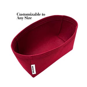 May include: A burgundy felt bag organiser with a rectangular shape and a white label that says "SILKON". The text "Customizable to Any Size" is above the bag. The organiser is designed to fit inside a larger bag to help organise items.
