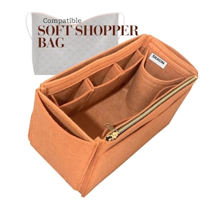 May include: An orange felt bag organizer with multiple compartments and a gold zipper. The text "Compatible SOFT SHOPPER BAG" is visible in the background. A small white tag reads "SILKON".