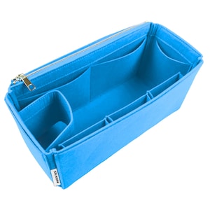 Pode incluir: Um organizador de bolsa de feltro azul brilhante com vários compartimentos e fecho de correr. O organizador tem formato retangular com vários bolsos e divisórias para armazenamento. O zíper e os acessórios são dourados. A marca "SIKON" é visível.