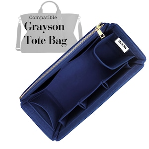 May include: A navy blue tote bag organizer with multiple compartments and a gold zipper. The organizer is designed to fit a Grayson Tote Bag. The text "Compatible Grayson Tote Bag" is displayed above the organizer.
