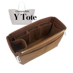 May include: A brown felt bag organizer with multiple compartments and a gold zipper. The organizer is designed to fit inside a Y Tote bag. The text "Compatible Y Tote" is in the background.