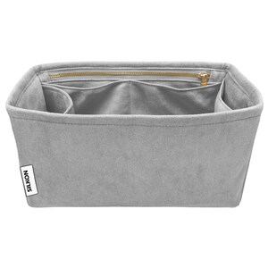 May include: A gray bag organizer with multiple compartments and a zippered top closure. The organizer has a rectangular shape and is made of a soft, suede-like material. The brand name "SILKON" is visible on a white label.