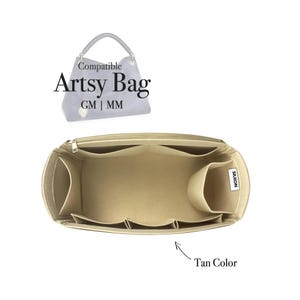 May include: A tan-coloured bag organiser with multiple compartments, designed to fit inside an Artsy Bag. The organiser has a zipped top and several pockets of varying sizes. The text "Compatible Artsy Bag GM | MM" is visible.