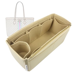 May include: Beige felt handbag organizer with multiple compartments and a gold zipper. The organizer is designed to fit inside a tote bag, with a transparent tote bag outline in the background. The organizer has several pockets for storage.