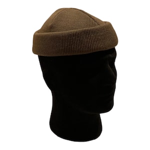 May include: A brown knitted beanie with a rounded crown and a folded brim.