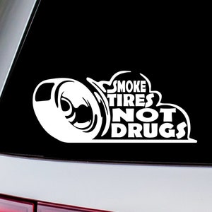May include: White vinyl decal sticker with a cartoon tire and smoke coming out of it. The text reads "Smoke Tires Not Drugs".