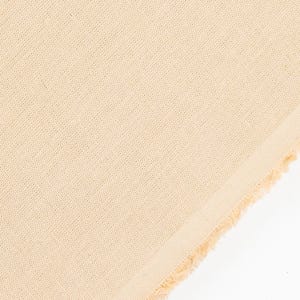 May include: Close-up of a beige linen fabric with a textured weave. The fabric has a raw, unfinished edge on the right side, revealing the natural fibers. The color is a soft, neutral tone, suitable for various textile projects.