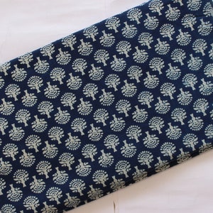 May include: A blue cotton fabric with a white floral pattern. The fabric is folded in half and has a small brown tag with the text "ShiboriNTieDye" on it.