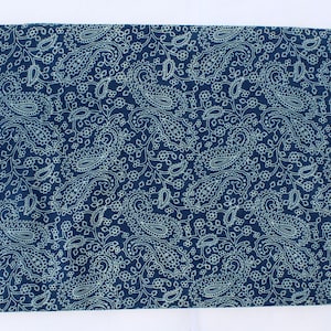May include: A dark blue fabric with a white paisley pattern. The fabric is soft and has a subtle sheen.