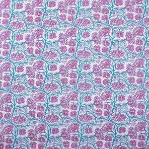 May include: A white fabric with a repeating pattern of pink flowers and blue vines. The flowers are stylised and have a detailed design.