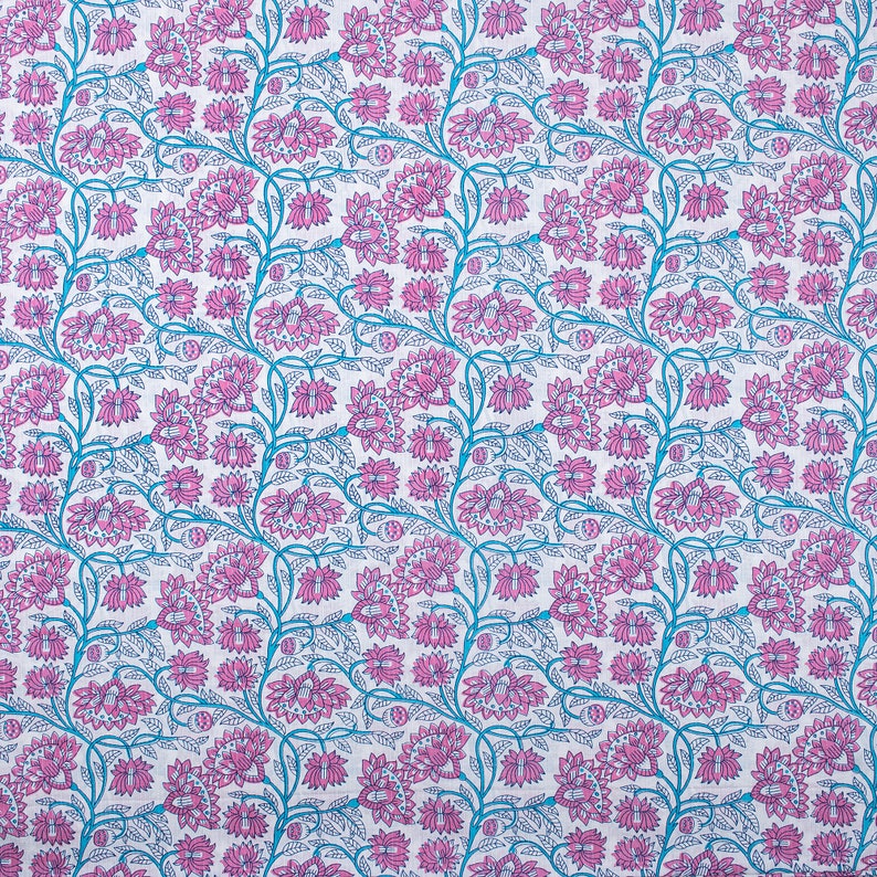 May include: A white fabric with a repeating pattern of pink flowers and blue vines. The flowers are stylised and have a detailed design.