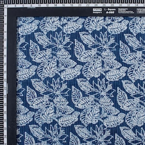 May include: Blue cotton fabric with a white leaf pattern. The fabric has a subtle texture and is perfect for quilting or other craft projects.
