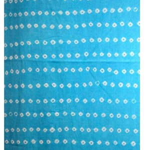 May include: A blue fabric with a white diamond pattern. The fabric is a shibori tie-dye pattern.
