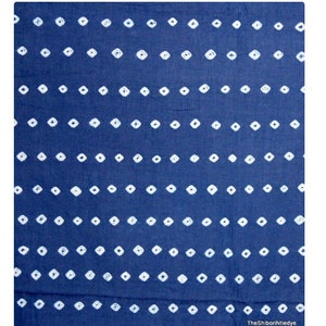 May include: A blue fabric with a white diamond pattern. The fabric is a traditional Indian textile.