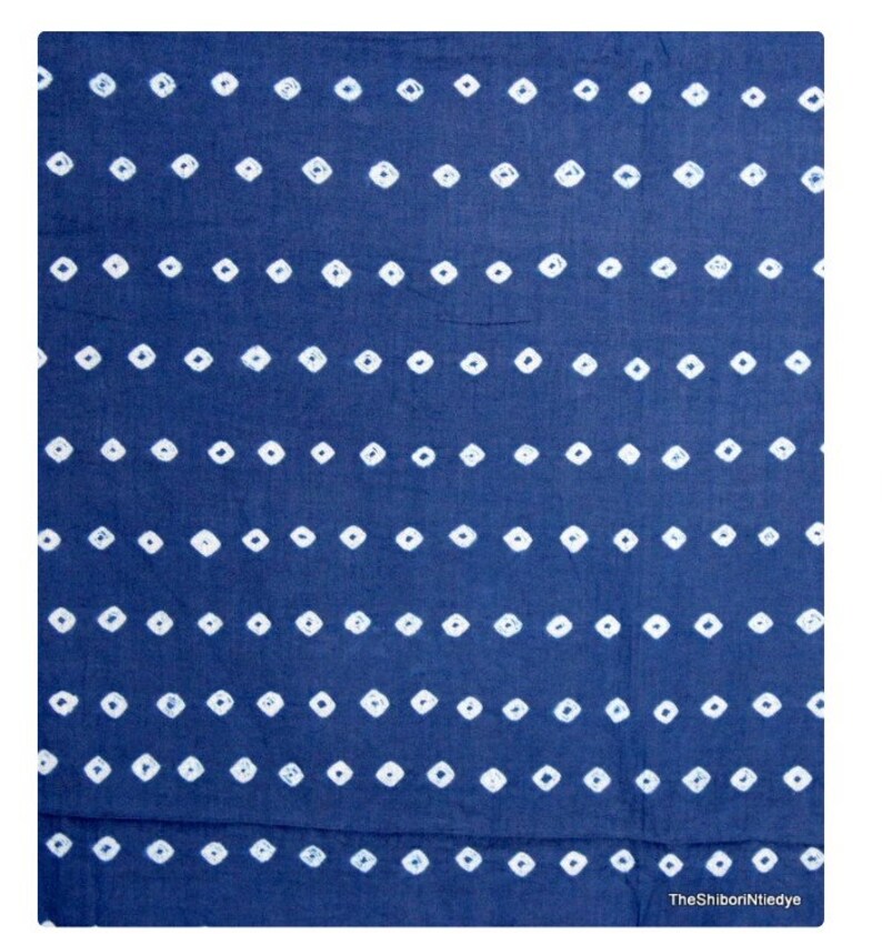 May include: A blue fabric with a white diamond pattern. The fabric is a traditional Indian textile.