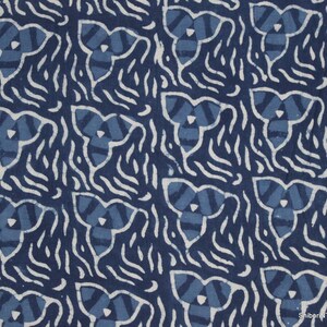 May include: Indigo blue fabric with a white pattern of repeating three-leaf clover shapes and wavy lines. The fabric has a hand-dyed, tie-dye look.