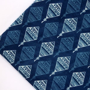 May include: Blue cotton fabric with a white diamond pattern. The diamonds are filled with a geometric design.