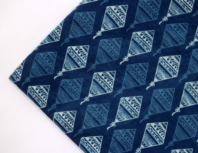 May include: Blue cotton fabric with a white diamond pattern. The diamonds are filled with a geometric design.