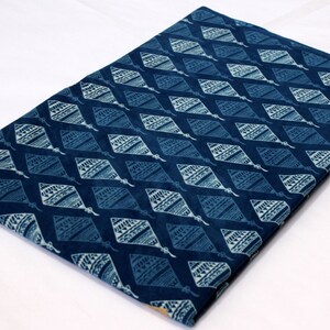 May include: A blue cotton fabric with a white diamond pattern. The fabric has a traditional Indian design.