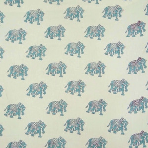 May include: A white fabric with a repeating pattern of blue elephants. The elephants are facing right and have a detailed design.