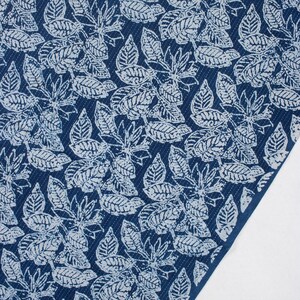 May include: Blue fabric with a white leaf pattern. The fabric has a textured surface.