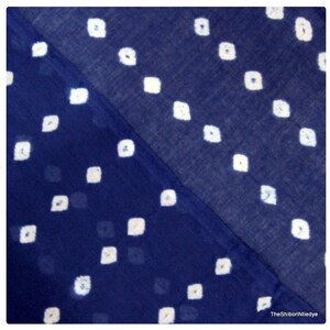 May include: A blue fabric with a white diamond pattern. The fabric is folded in half, showing two different sides of the pattern.